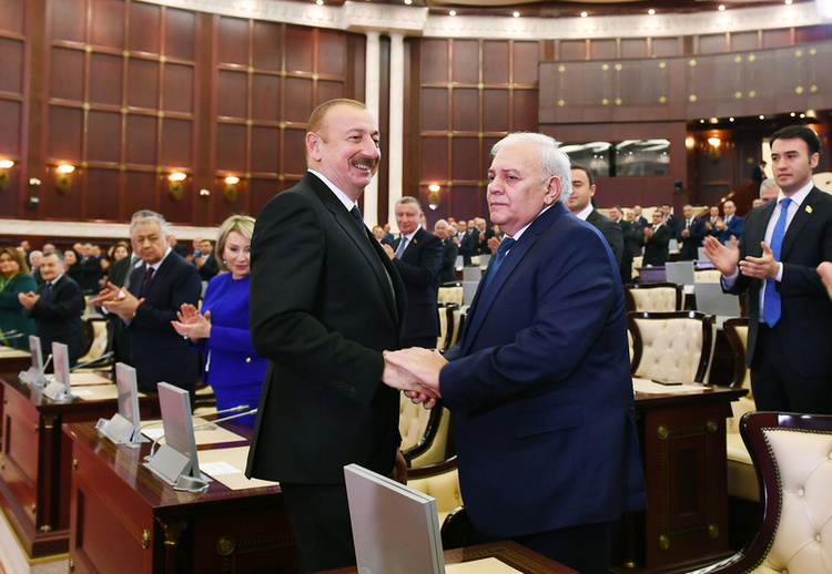 President Aliyev shakes hands with Oktay Asadov