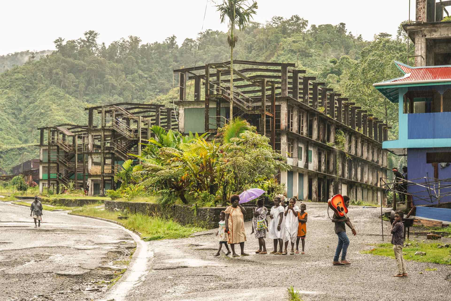 Locals walk by buildings left abandoned tidttiqzqiqkdprw qhiqqkiqhriqqtinv